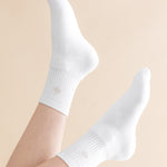 White socks worn on a beige background