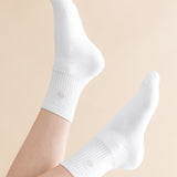 White socks worn on a beige background