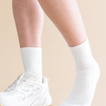 White socks and sneakers on a beige background