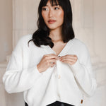 Woman looking to the side buttoning her cropped cardigan in cloud
::: Model is 5'9" wearing size S ///