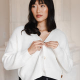 Woman looking to the side buttoning her cropped cardigan in cloud
::: Model is 5'9" wearing size S ///