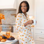 Model holding a coffee mug in kitchen wearing Long-Sleeved Women's Pajama Set in Croissant print
---1605 1