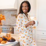 Model holding a coffee mug in kitchen wearing Long-Sleeved Women's Pajama Set in Croissant print
---1605 1