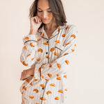 Model posing in Long-Sleeved Women's Pajama Set in Croissant print on a beige background