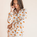 Model posing in Long-Sleeved Women's Pajama Set in Croissant print on a beige background