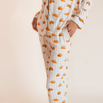 Model wearing Long-Sleeved Women's Pajama Set in Croissant print with pockets on a beige background
---PJ 4