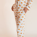 Model wearing Long-Sleeved Women's Pajama Set in Croissant print with pockets on a beige background
---PJ 4
