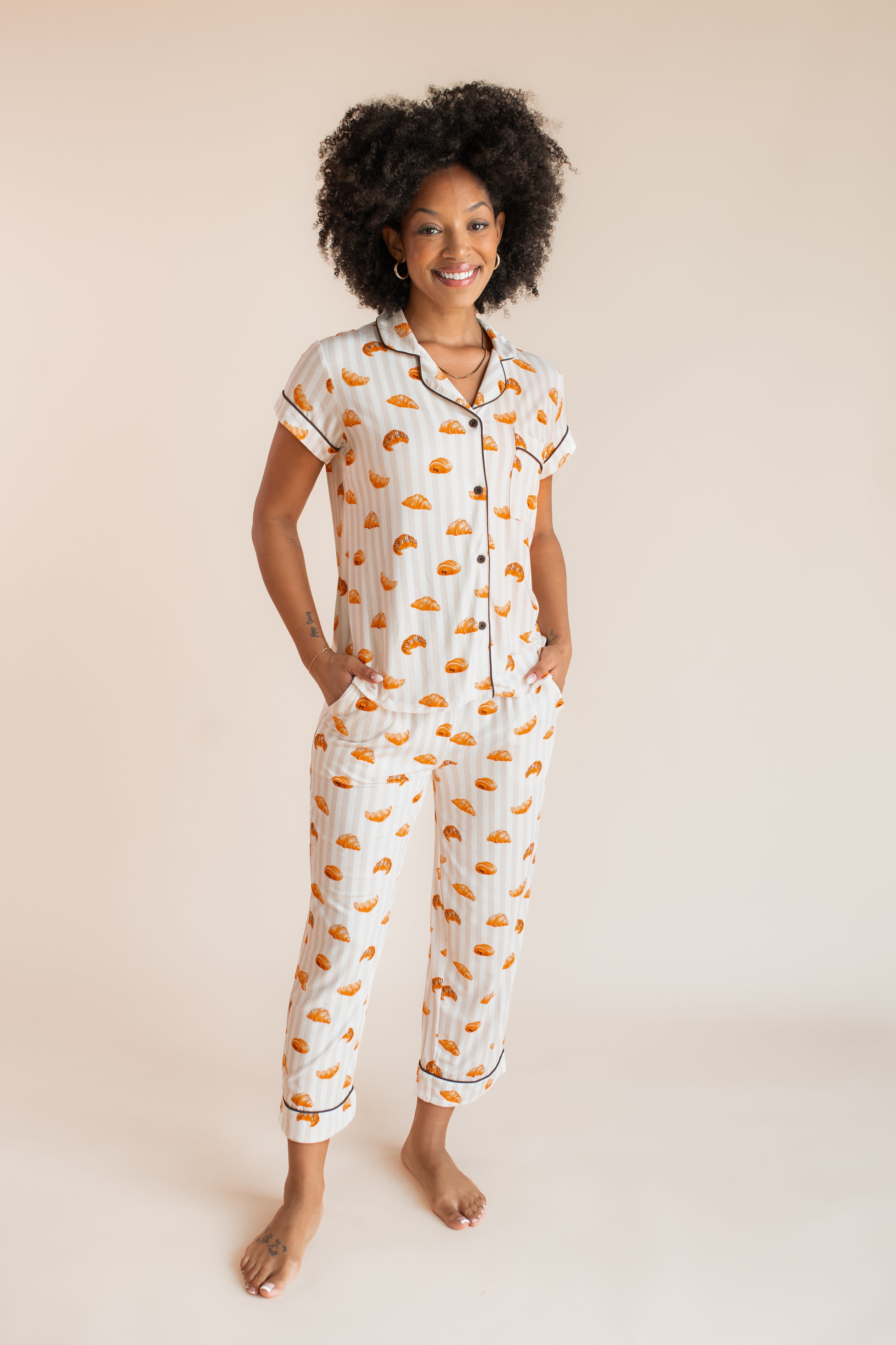 Model posing in Women's Short Sleeve Cropped Pajama Set in Croissant print on a beige background
---PJ 4