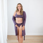 Woman in Scoop Neck Bralette in Currant and matching underwear and lounge robe