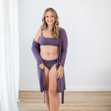 Woman in Scoop Neck Bralette in Currant and matching underwear and lounge robe