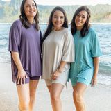 Three models on the beach wearing the Women’s Biker Short Set in various colors 