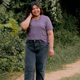 Female model wearing the Women's Crew Neck Tee in Currant paired with black jeans