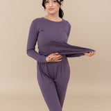 Model stretching the jogger top to show the elasticity of the fabric in the Women's Jogger Pajama Set in Currant