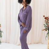 Smiling model wearing the Women's Long Sleeve Pajama Set in Currant with Cloud Trim