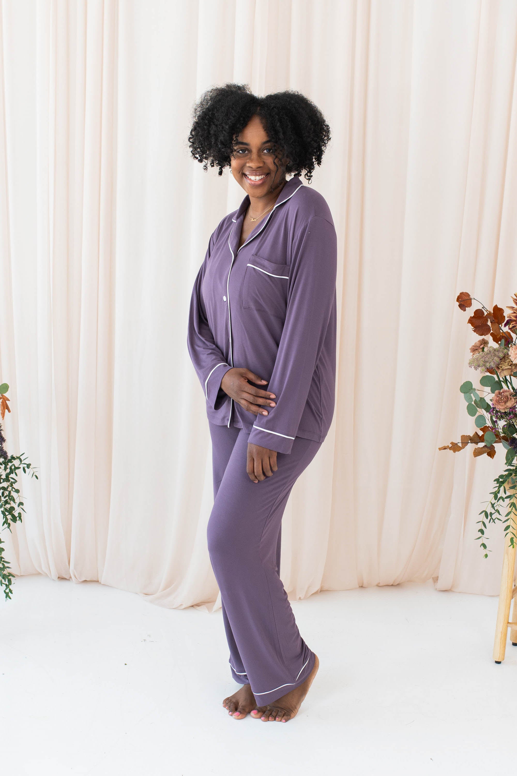 Smiling model wearing the Women's Long Sleeve Pajama Set in Currant with Cloud Trim
