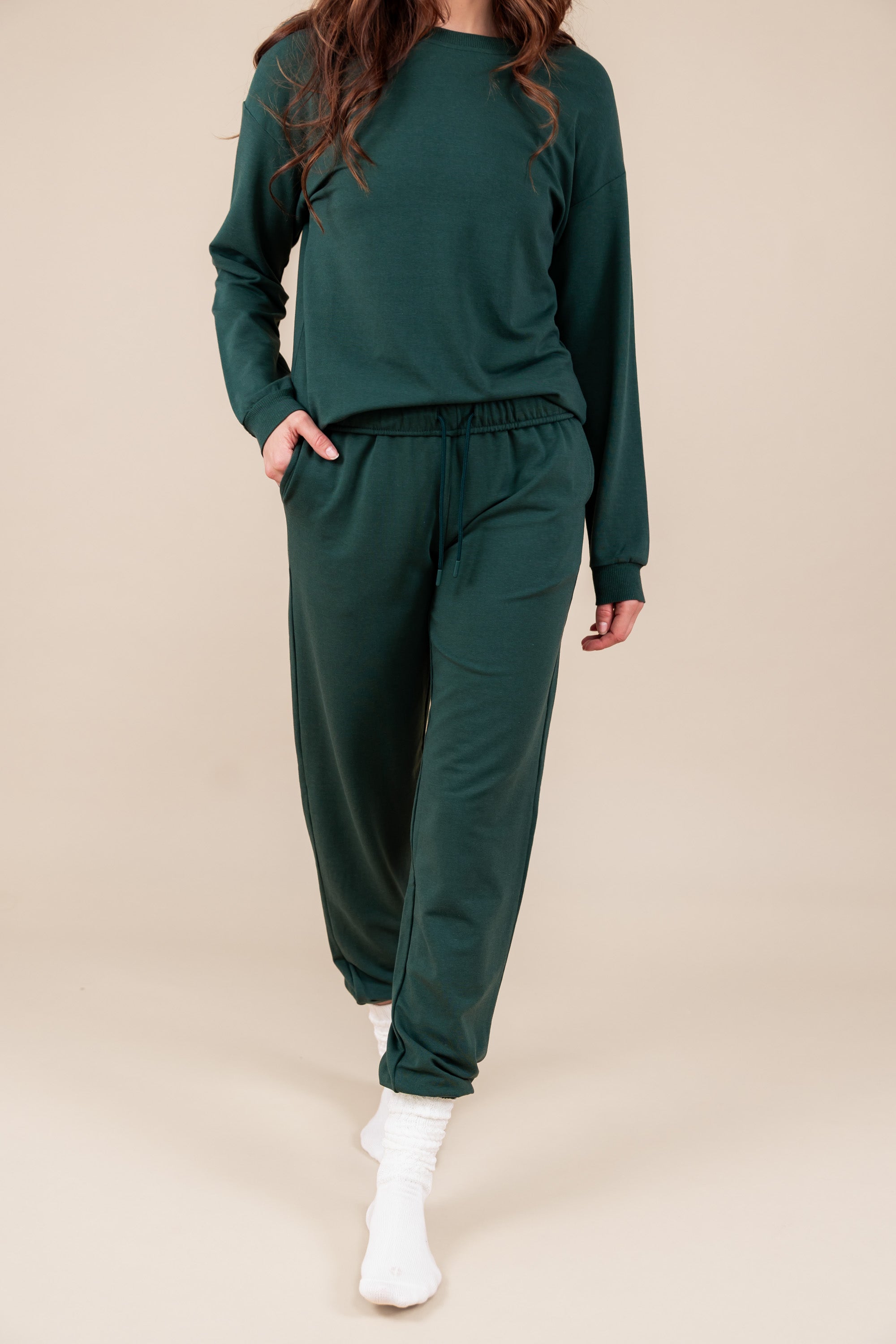 Modal wearing Women's Jogger Pant in Cypress color under similar color sweatshirt on a beige background
::: Model is 5'10" wearing size S ///