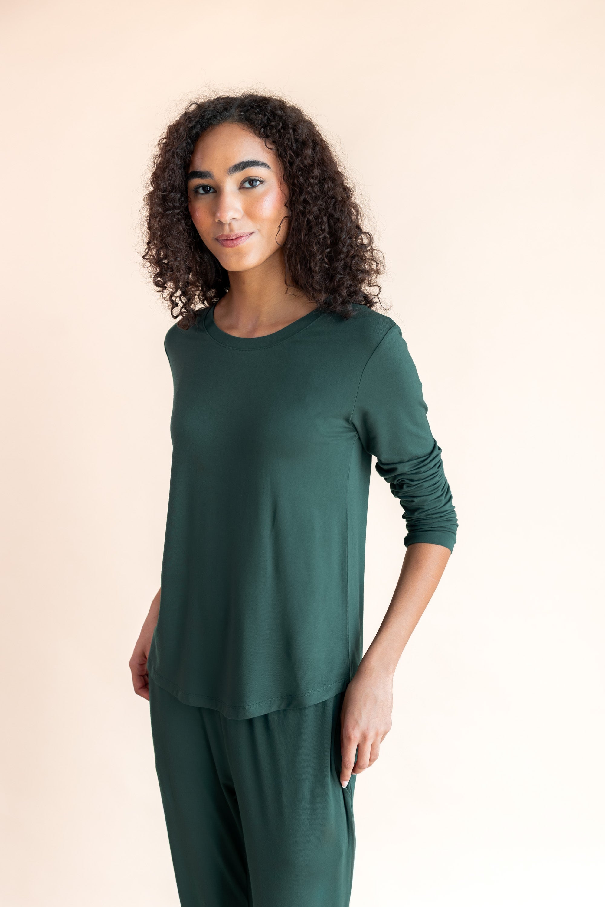 Woman soft smiling standing angled in jogger pajama set in cypress