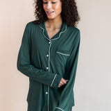 Woman pulling up her sleeve looking down wearing long sleeve pajama set in cypress

---PJ 4