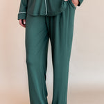 Bottom half of a woman with her hand in her pant pocket wearing long sleeve pajama set in cypress

---1605 3