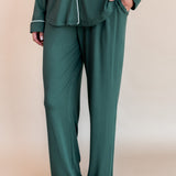 Bottom half of a woman with her hand in her pant pocket wearing long sleeve pajama set in cypress

---1605 3