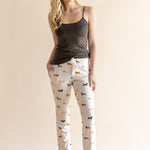 Model wearing Women's Lounge Pants in Dachshund paired with a camisole in espresso background ::: Model is 5'9" wearing size XS ///