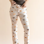 Model showing the drawstring of Women's Lounge Pants in Dachshund print under a brown camisole on a beige background