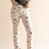 Model showing the drawstring of Women's Lounge Pants in Dachshund print under a brown camisole on a beige background
