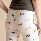 Model showing the back of Women's Lounge Pants in Dachshund print under a brown camisole on a beige background