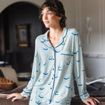 Modal posing in Long-Sleeved Women's Pajama Set in Dew Mahjong print standing against a sofa in a living room

---PJ 2