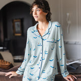 Modal posing in Long-Sleeved Women's Pajama Set in Dew Mahjong print standing against a sofa in a living room

---PJ 2