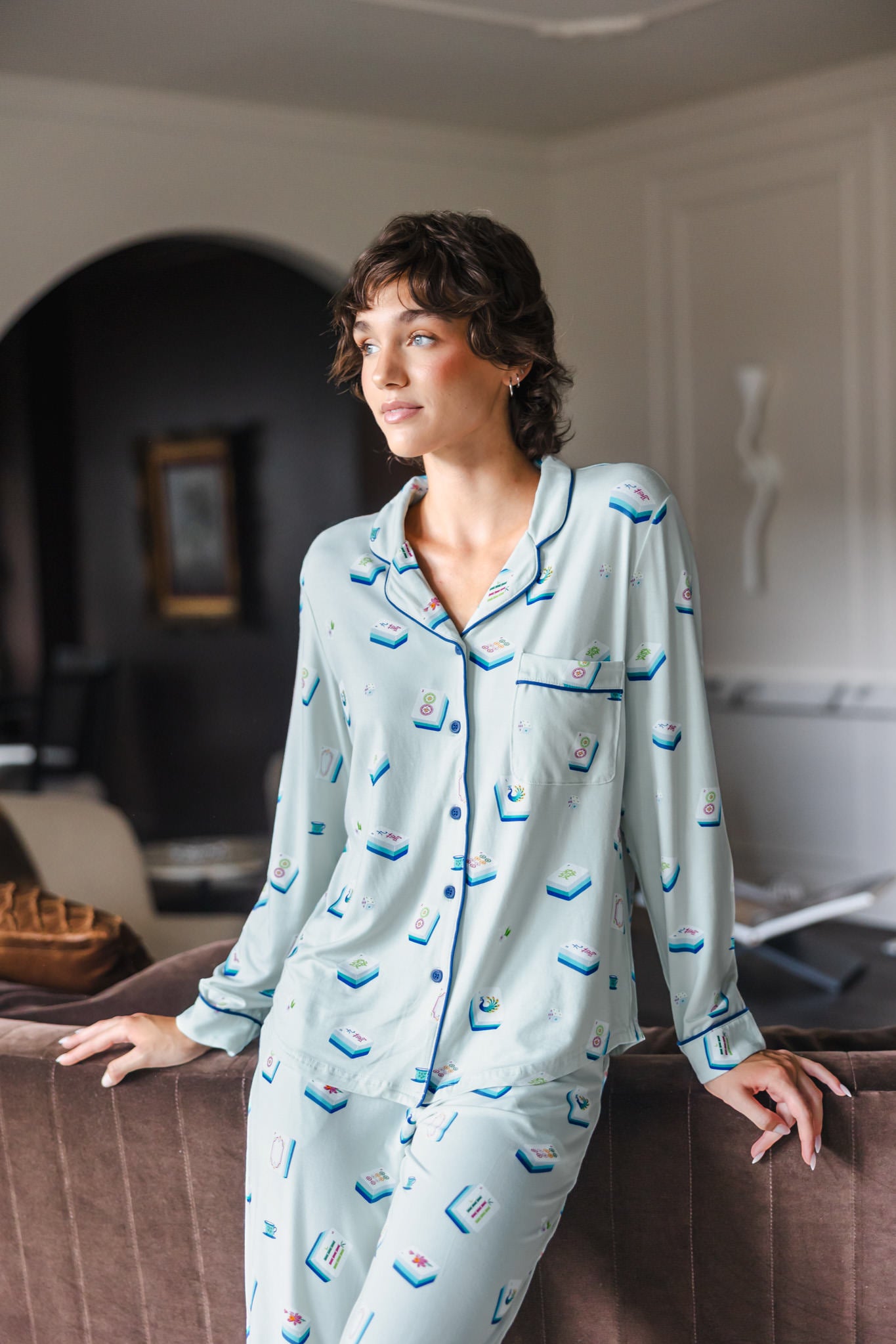 Modal posing in Long-Sleeved Women's Pajama Set in Dew Mahjong print standing against a sofa in a living room

---PJ 2