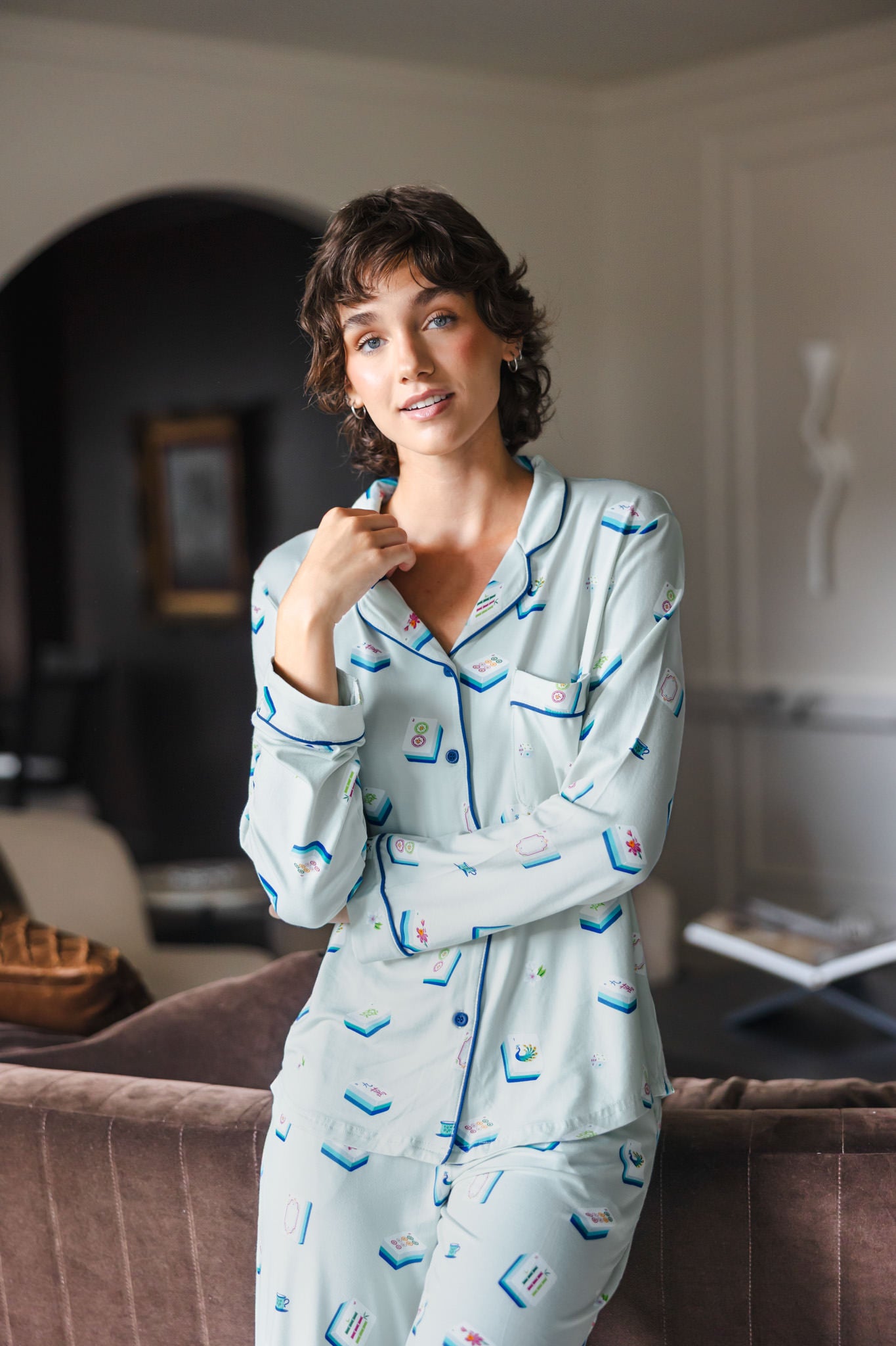 Modal wearing Long-Sleeved Women's Pajama Set in Dew Mahjong print standing against a sofa in a living room ---1605 1