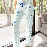 Close up of the Women's Lounge Pants in Dew Mahjong on a model leaning against a large window

::: Model is 5'10" wearing size S ///