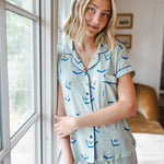 woman wearing light green short sleeve pajama set with mahjong tile print standing against a window

::: Model is 5'10" wearing size XS ///