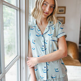 woman wearing light green short sleeve pajama set with mahjong tile print standing against a window

::: Model is 5'10" wearing size XS ///