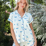 Model standing in front of shrubs while wearing the Women's Short Sleeve Pajama Set in Dew Mahjong

::: Model is 5'11" wearing size S ///