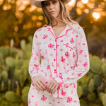 Female modeling the Long-Sleeved Women's Pajama Set in Disco Cowgirl outside in front of trees and cacti  ::: Model is 5'11" wearing size S ///