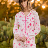 Female modeling the Long-Sleeved Women's Pajama Set in Disco Cowgirl outside in front of trees and cacti  ::: Model is 5'11" wearing size S ///