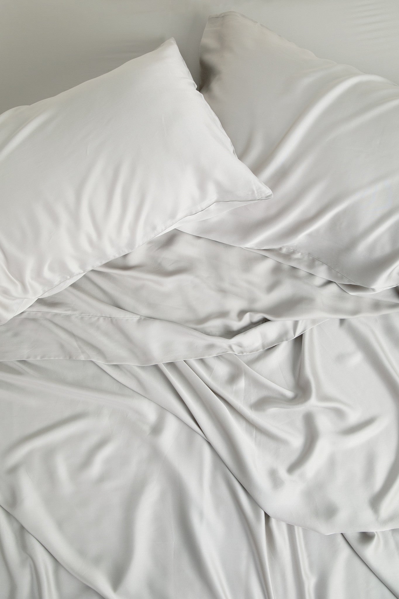 Close up of the Bamboo Sateen Sheet Set in Dove Gray shown on a bed