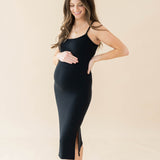 Expectant mother wearing the Women's Ribbed Cami Dress in Midnight with one hand on top of her baby bump