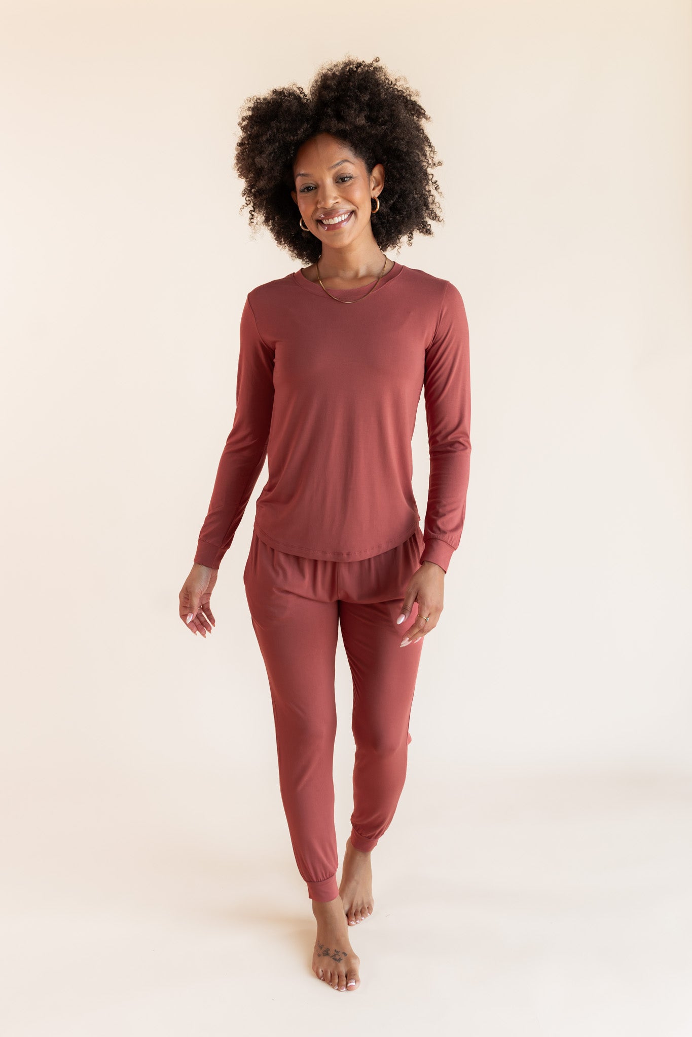 Woman modeling a jogger pajama set in a terracotta color 
::: Model is 5'9"" wearing size S ///
