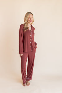 Model wearing Long-Sleeved Women's Pajama Set in Ember with a cloud trim on a beige background