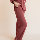 Model showcasing pockets on Long-Sleeved Women's Pajama Set in Ember on a beige background
---1605 3