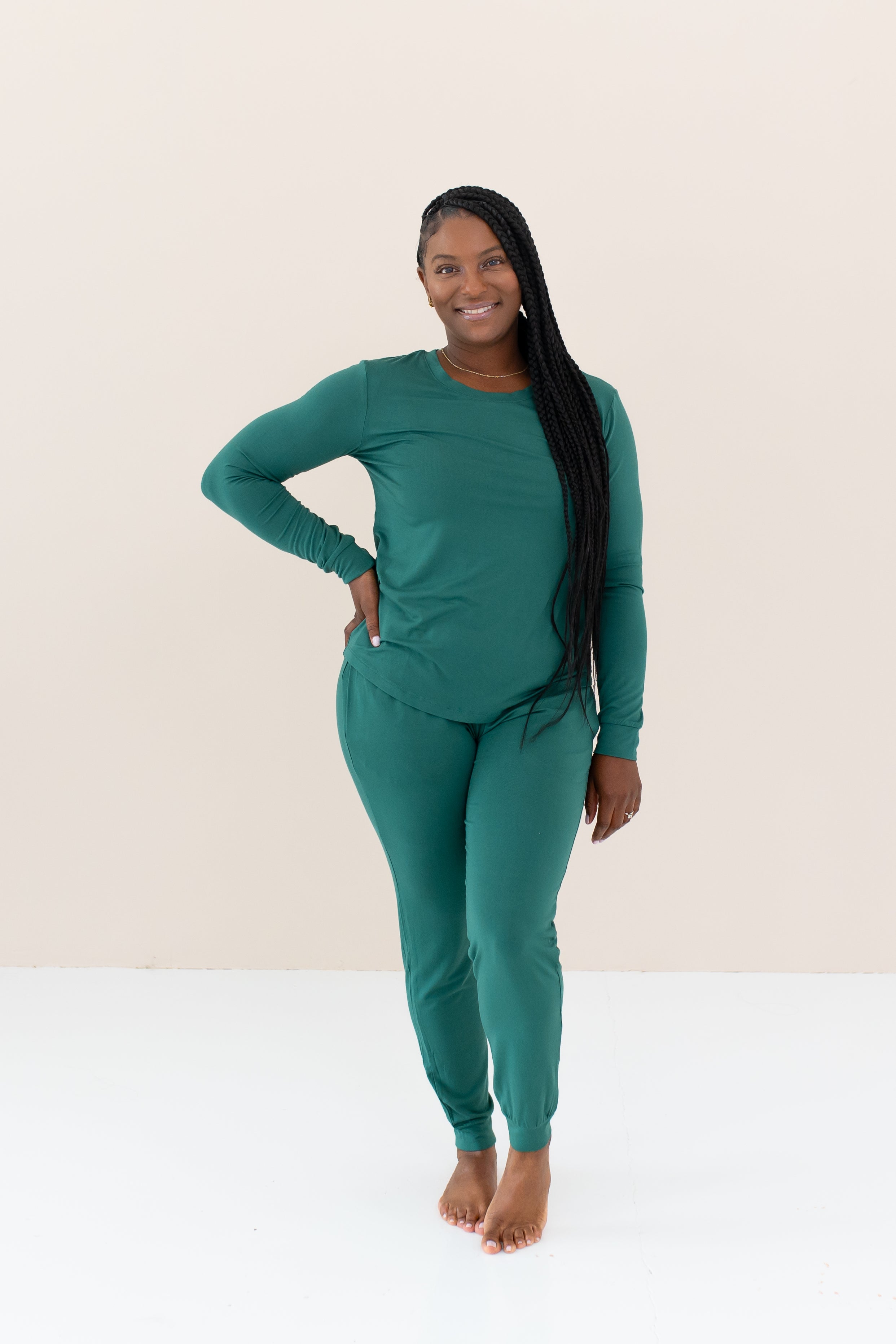Woman modeling Women's Jogger Pajama Set in Emerald with hand on hip with braided hair in front of shoulder