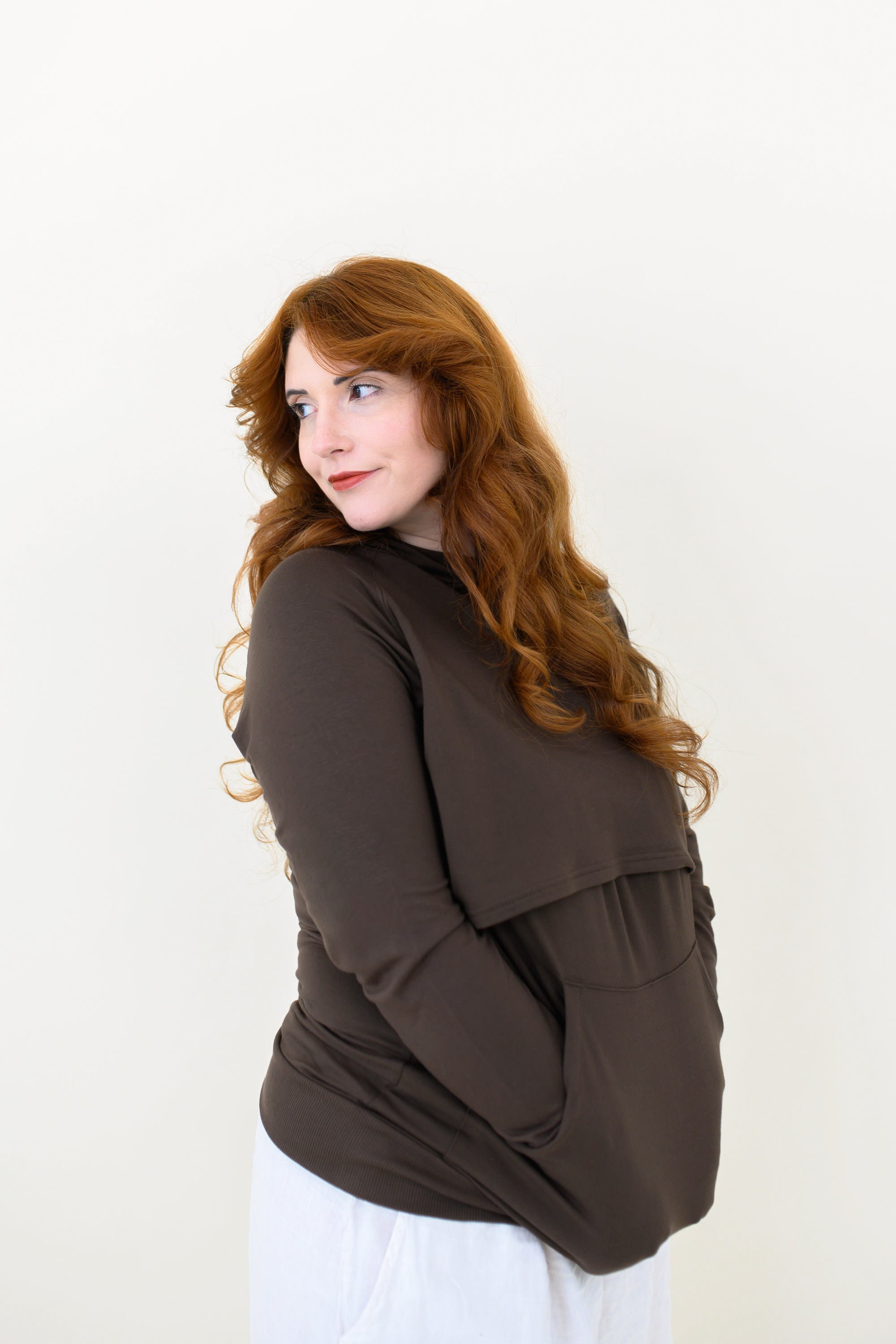 Female modeling the Women's French Terry Nursing Hoodie in Espresso with her hands in the kangaroo pocket