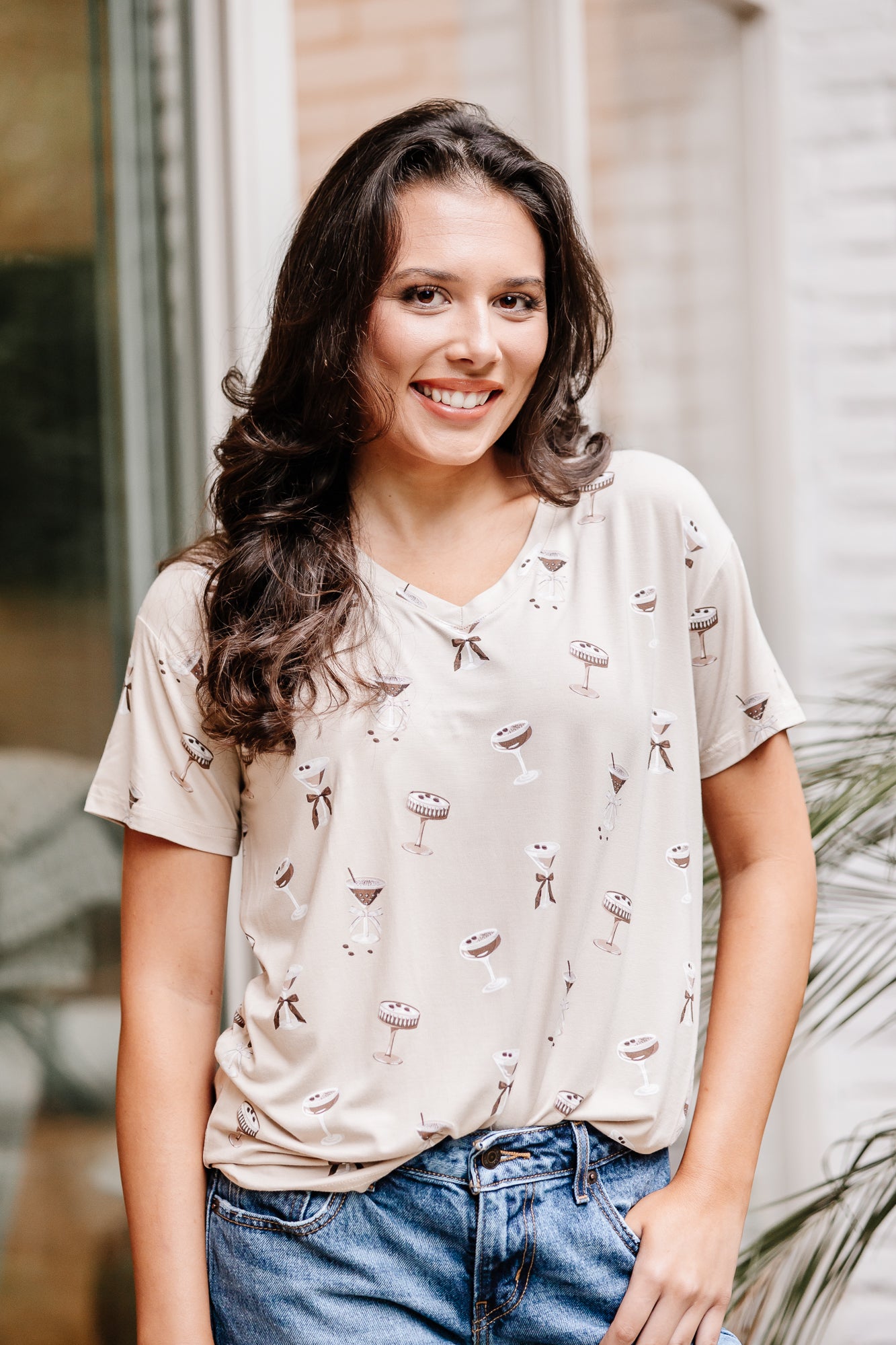 Smiling model wearing the Women's Relaxed Fit V-Neck in Espresso Martini paired with light jeans