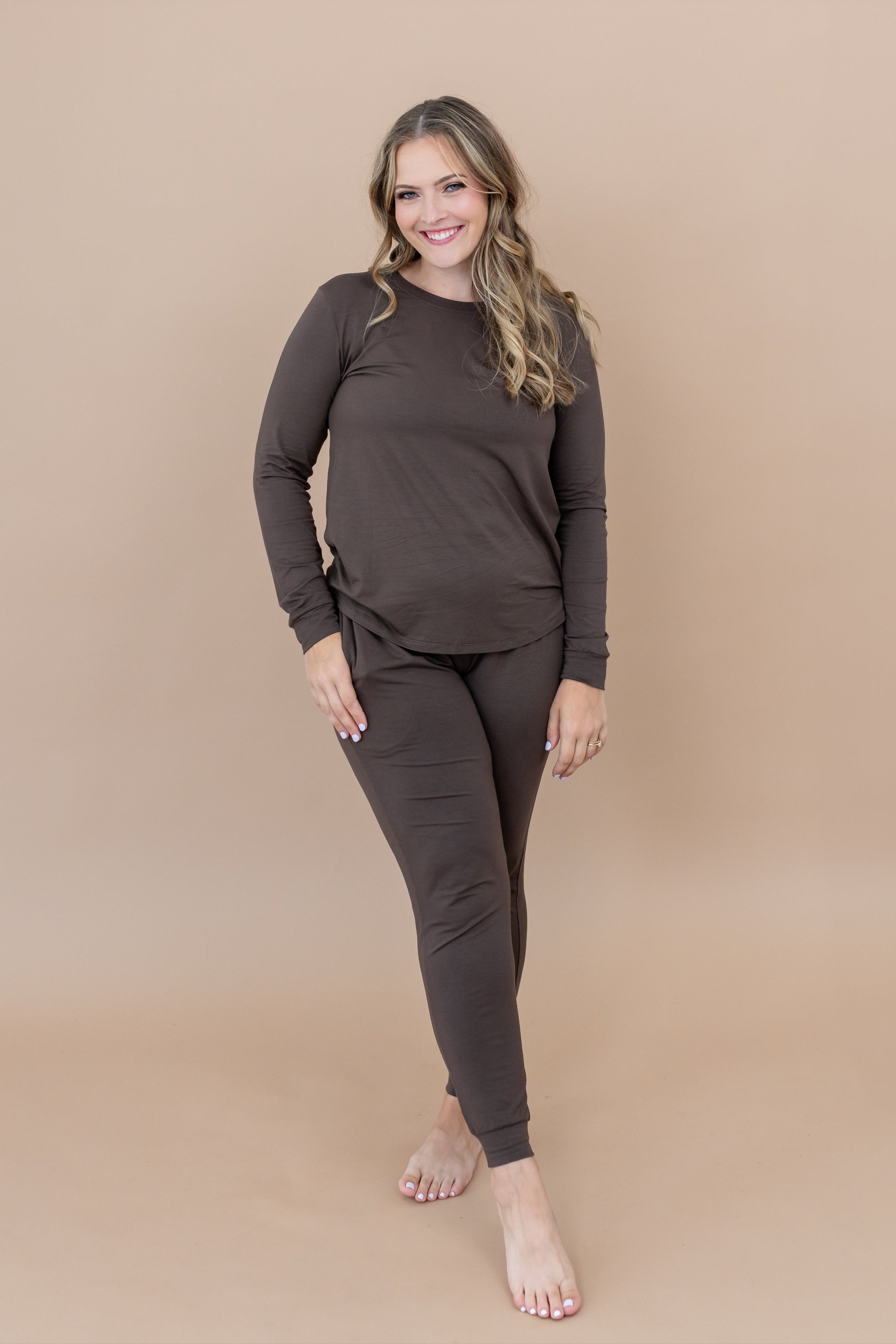 Smiling model wearing the Kyte Women's Jogger Set in Espresso 