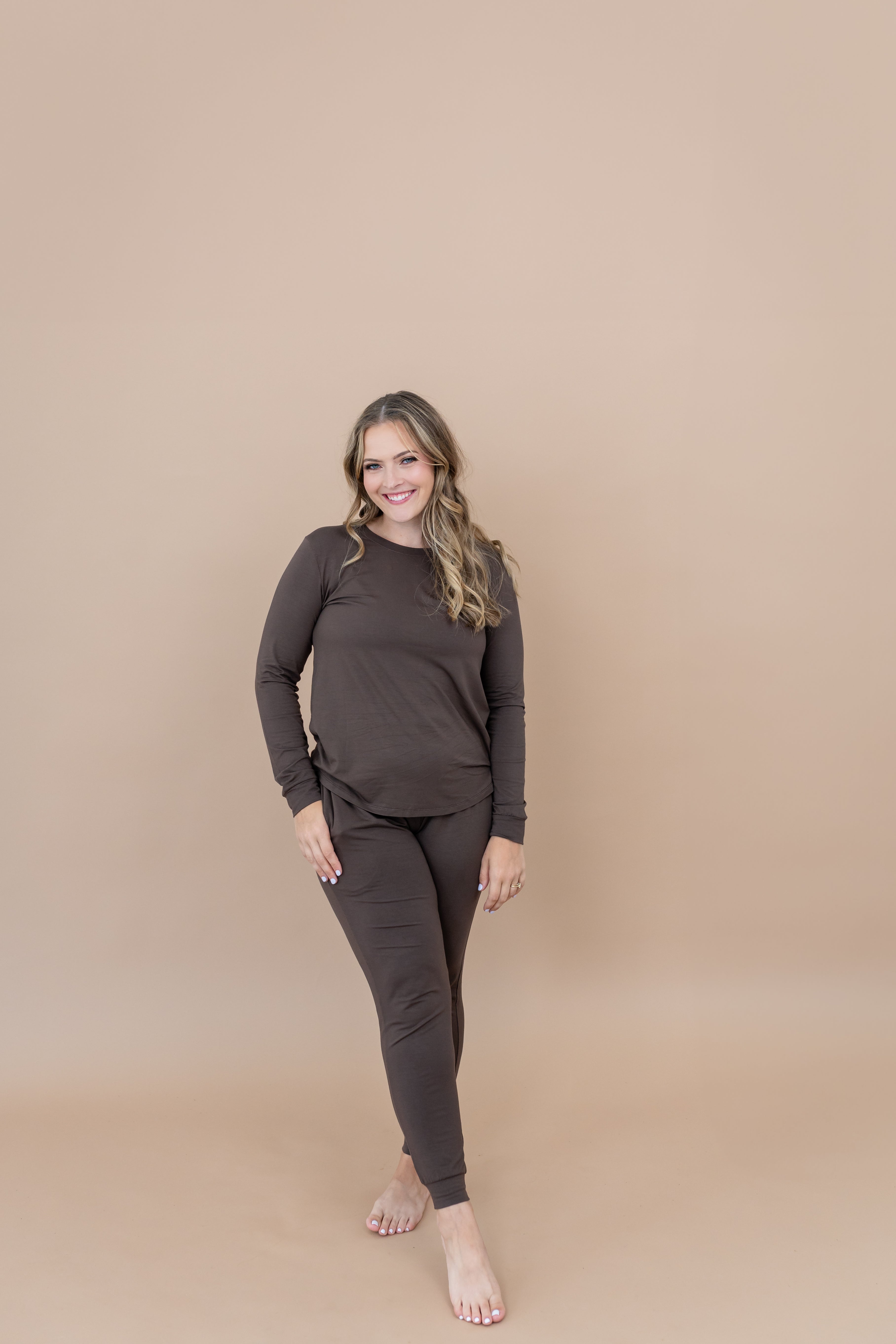 Smiling model wearing the Kyte Women's Jogger Set in Espresso 