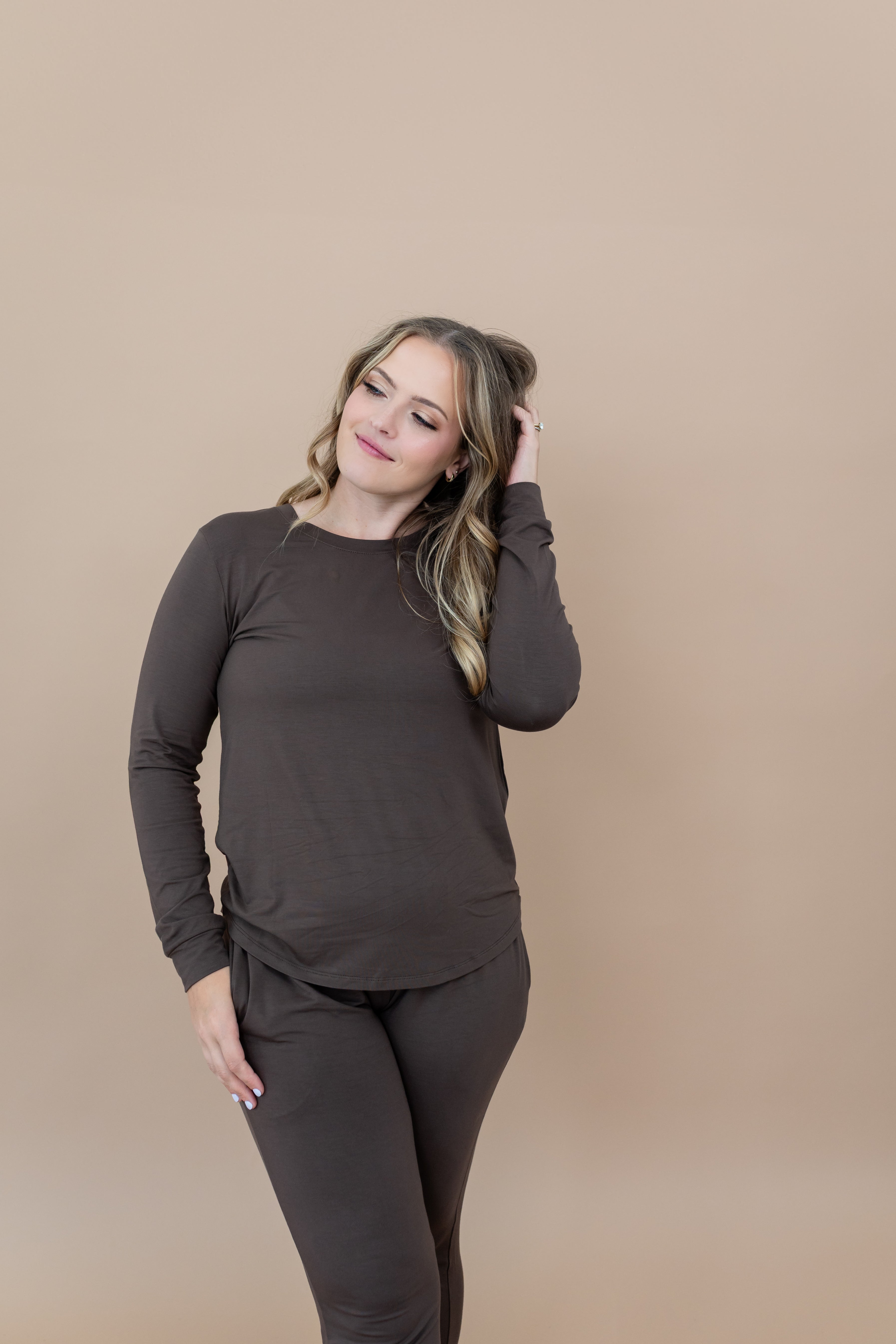 Model with hand in hair while wearing the Women's Jogger Set in Espresso 