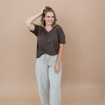 Smiling model with  her hand in her hair while modeling the Women's V Neck in Espresso 